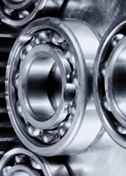 Close-up view of metal ball bearings and gear cogs, their shiny surfaces enhanced by discontinued Teflon™ Severe Service Grease for smooth, reliable machinery operation.