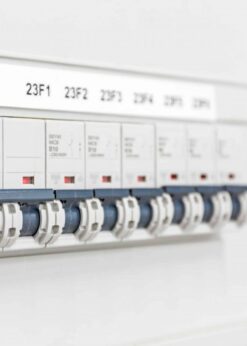 Close-up of an electrical breaker panel with labeled switches, featuring white housings and red indicators—reliably protected and ideal for use with specialized products like Electronic Cleaning Agent | MS-730L Contact Re-Nu®.