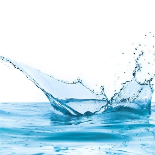 A splash of water creating droplets in a clear blue water surface.